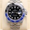 Luxury watch on wrist with blue and black bezel