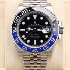 Luxury watch on wrist with blue and black bezel