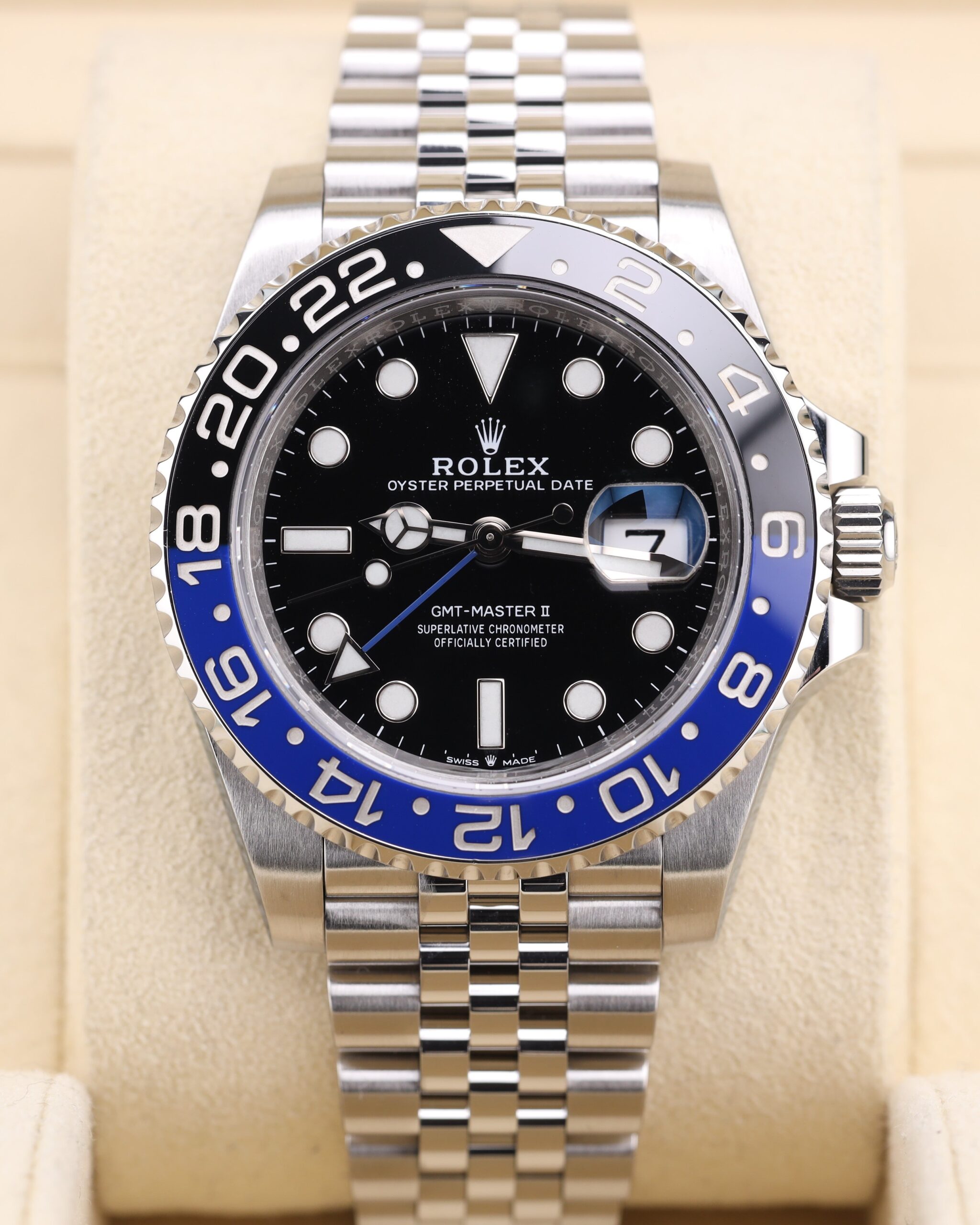 Luxury watch on wrist with blue and black bezel
