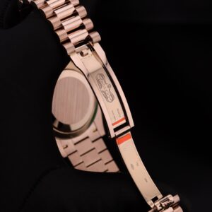 Luxury watch with pink bezel and diamond accents