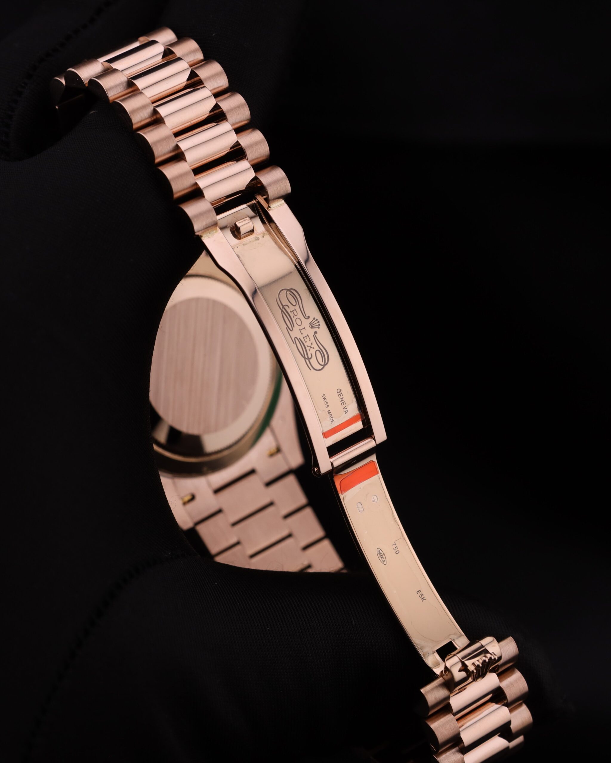 Luxury watch with pink bezel and diamond accents