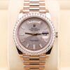 Pink bezel watch on wrist with diamond markers