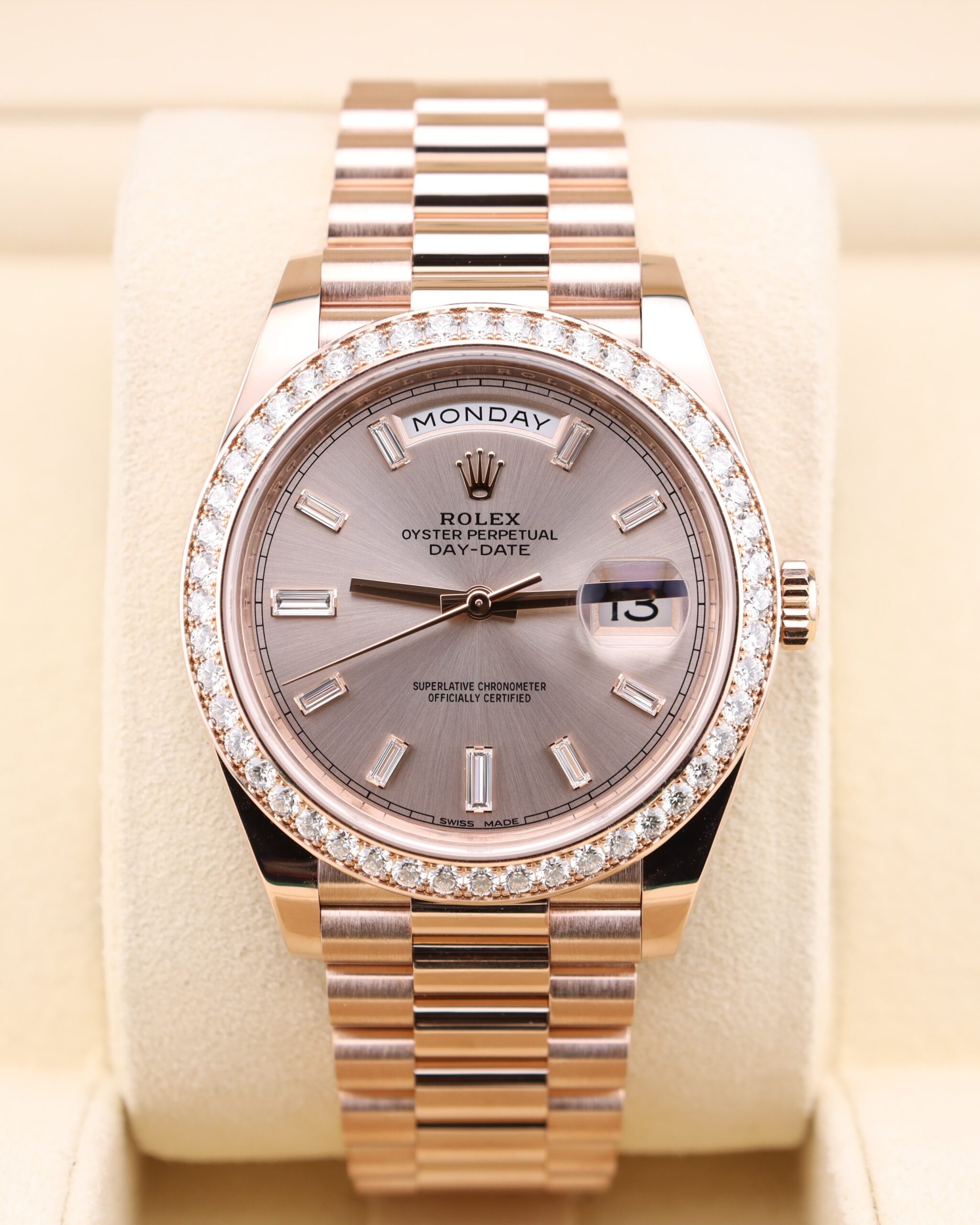 Pink bezel watch on wrist with diamond markers