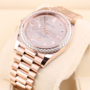 Pink bezel watch on wrist with diamond accents