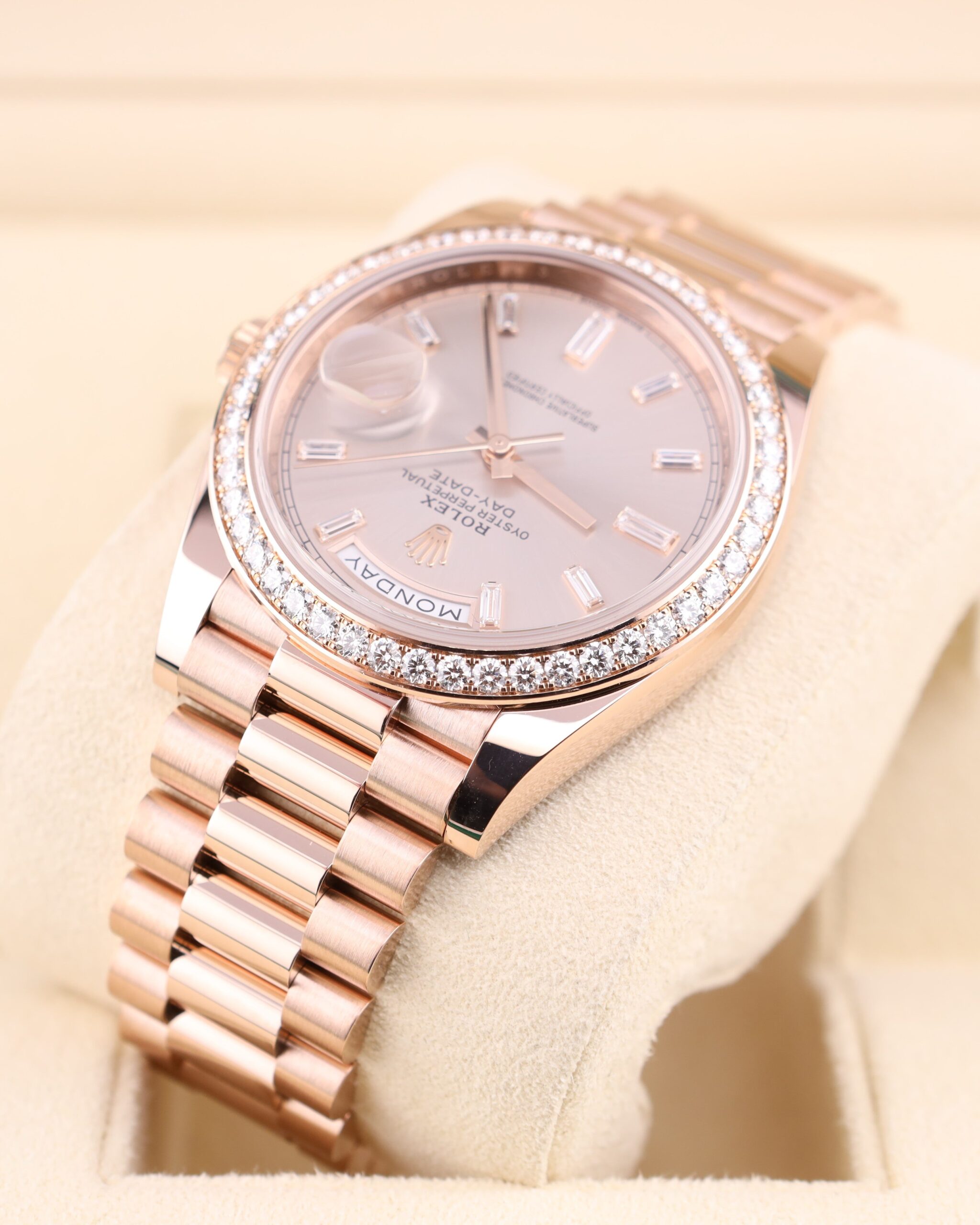 Pink bezel watch on wrist with diamond accents