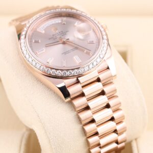 Pink bezel luxury watch with diamond bezel close-up