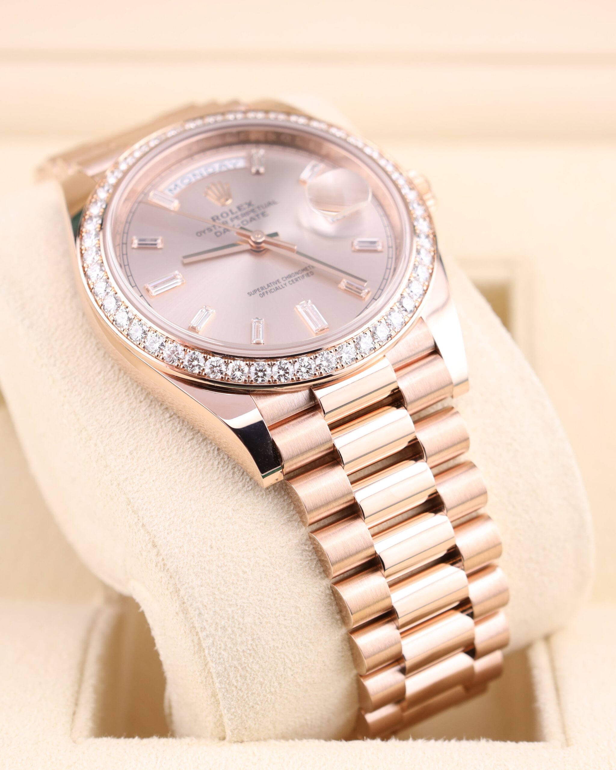 Pink bezel luxury watch with diamond bezel close-up
