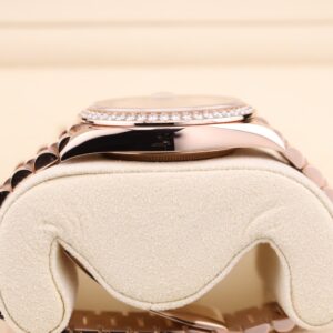 Side profile of pink bezel watch with diamonds