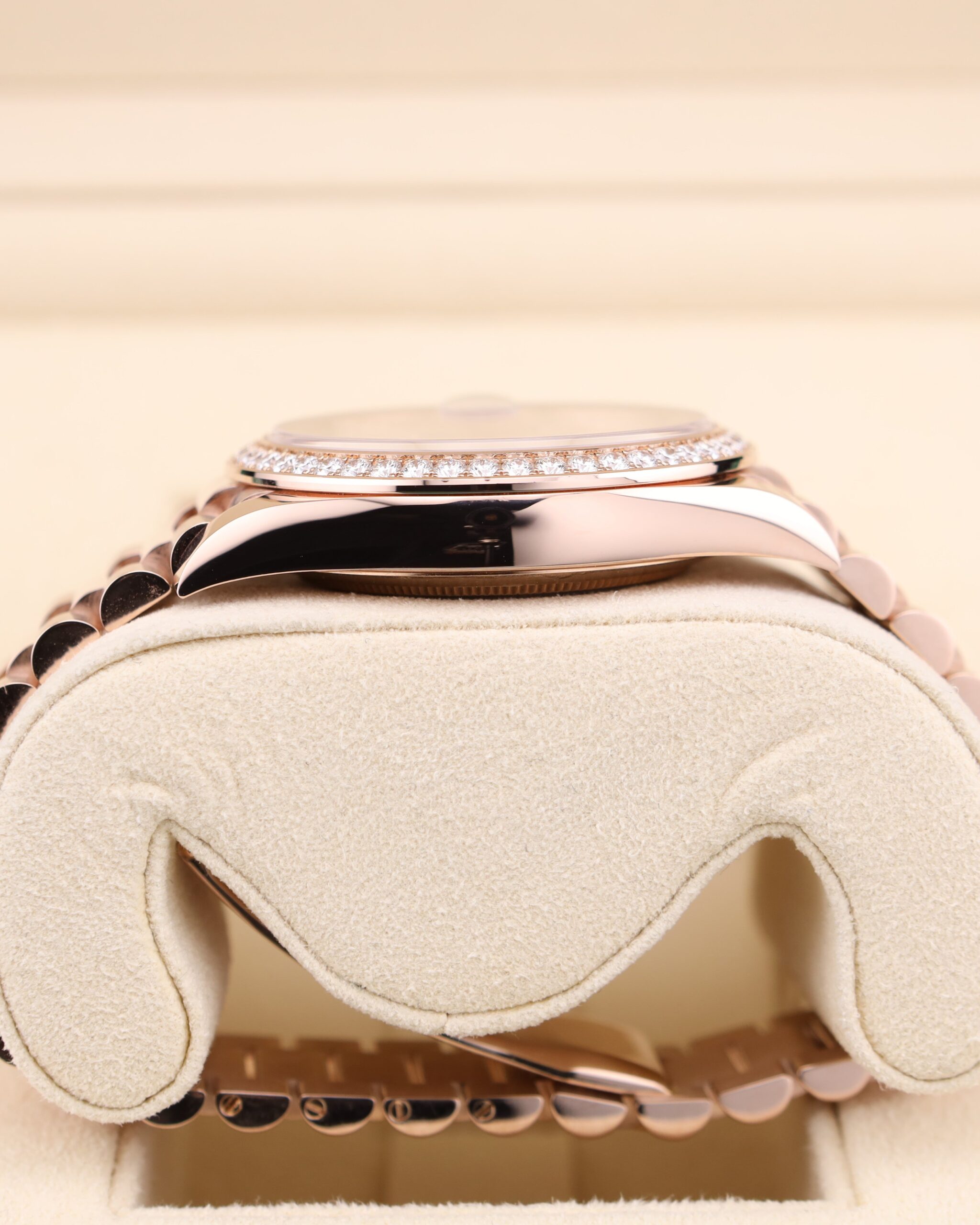 Side profile of pink bezel watch with diamonds