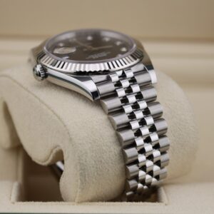 Close-up of black dial watch with diamond indices