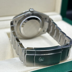 Green dial luxury wristwatch close-up