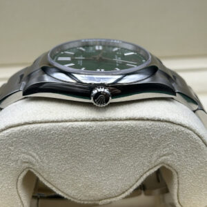 Green dial wristwatch on wrist