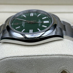 Green dial luxury wristwatch close-up