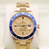 Rolex Submariner in yellow gold on wrist